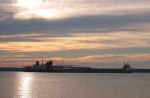 Lime Island anchorage. Self loading laker passing through channel at dusk.