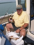 Good Friend and fishing buddy Ira. Excellent weather, calm water, imported German weiss beer, smoked whitefish for lunch, fresh herring in the cooler - Life is great!