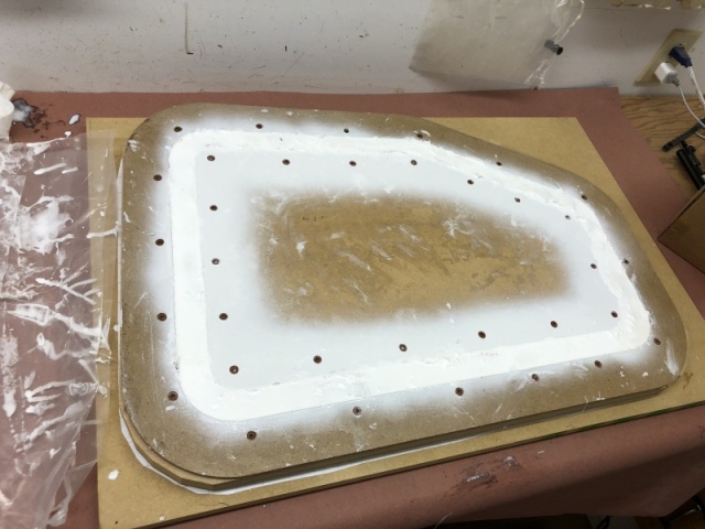 Mold has been filled with fiberglass and West System 105 epoxy resin with white color additive. I waited three days then I sanded the excess cured resin from the top of the mold before disasssembling the mold and releasing the part. I was nervous about it releasing but it easily popped free.