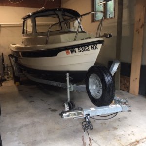 Yeah she fits! 2008 16 angler tucked in garage. Trailer tongue folded leaves 6 inches of lengthwise clearance.