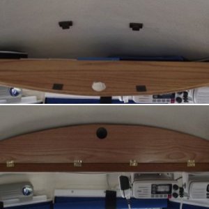 Overhead cabinet door held closed by magnetic catch