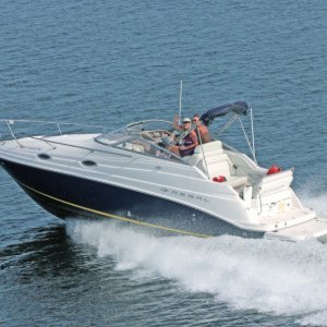 Prior trailer boat #12 (Regal 2665) on Pensacola Bay.  Professional photographer leaning out of a helicopter with one foot on the rail, on a gunners' belt.  Do Not try this at home.