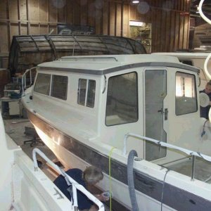Port side work. Rear windows and door are now in place. Looks like some finish buffing on the lower port area.  3/15/04