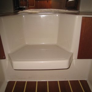 New larger teak trim cover plate for water tank access.