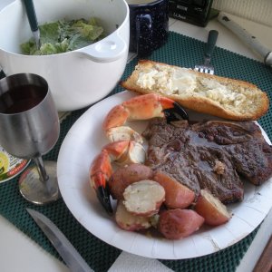 Media 'Our one non-seafood dinner.  Steak, potatoes, fresh salad, stone crab claws and toasted bread done on the grill.' in album 'Trying for a tropical mood shot while in SC.'