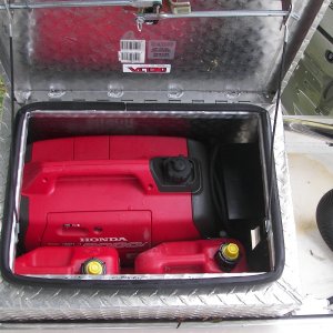 Without cutting openings, the box will hold a Honda i2000 and four, one gallon fuel tanks. I know about and have an extended run tank, but this works better for me now. You have to put the genset in exhaust first, vertically, then slide it to the left and drop front end down. This does not seem to spill oil, although sideways tilting will.