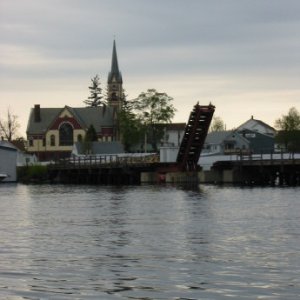 Railroad draw bridge and churh at tip of Paugus Bay.