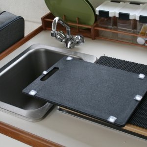 Pads glued on to keep the cutting board in place while underway