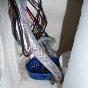 10. Wires and water line on the aft side of the water tank, on the port side, feeding into the white plastic chase under the cockpit floor.