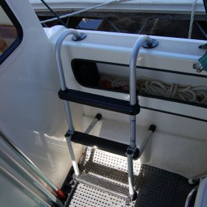 (Minnie Swann) I modified ladder by cutting off bottom rung and using leftover tubing to make standoff extensions. Can be used for boarding from dock or water on either side of gunnel