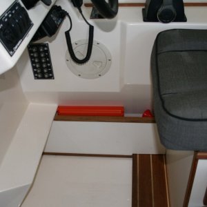 Another idea 'borrowed' from others - divider beneath the helm seat creates great space for flare kit, etc.