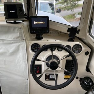 Reconfigured dash with compass down low, two chart plotters, and phone mount