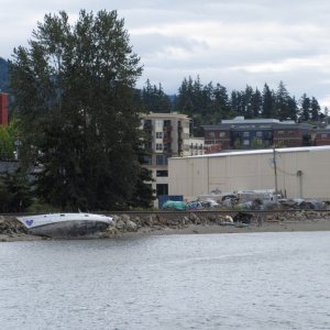 The transients apparently like to beach their sailboats along the waterfront because the following day there was another one just like this! If you look closely there are campers in tents on the beach. And that's NMI in the next building to the right.