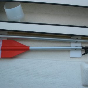 (Not For Hire) Two pieces of starboard glued to hull, screws and velcro on the starboard hold boat hook and paddle. Tested McNaughty style shelves but decided this was better for me.