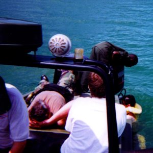 That's me in the water at the side of the port engine, trying to get this Rwandan patrol boat running before we drifted over to Congo