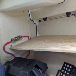 Port-side cuddy shelf. 3/4\" marine plywood. The long edge rests on the hull chine shape.