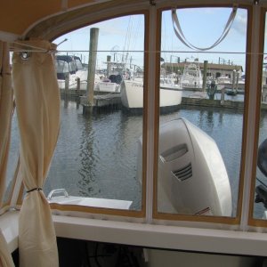07 Marinaut 215 cockpit temporary portable toilet enclosure folded up curtains starboard side.  Please notice that the folded up curtains do not obstruct our view.