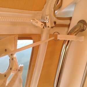This is a close-up of the clip attached to the hand.  Notice that the curtain can easily be drawn with the rope and clip in place.