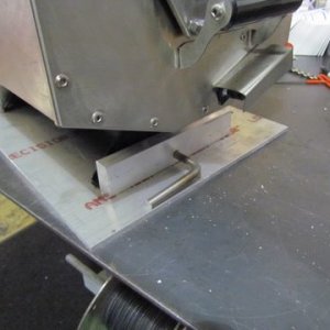 3/8 holes in aluminum uprights and the grills legs secures the grill to the plate by a round lock bar, The lock bar is 3/8 inch round 304 stainless steel.Drilled a hole in the end of the lock bar for a lock to prevent theft.Presently just have a hitch pin clip. Bent one end to serve as a handle to pull out locking bar. Will be adding some sound deadning materials