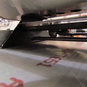 look close as the lock bar passes thru both the upright and the grills legs