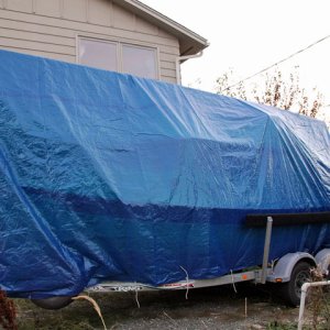 Media 'Port view of tarp tied to the frame of the trailer with bungee cords and lines.' in album '(AnchortownJim) Winter Storage 1, Cost $300, Used 1 year.'