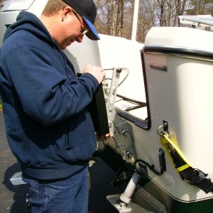 My buddy Charlie, a professional boat mechanic.  We need to make sure that there is clearance between the main and the kicker.