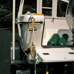 Hand holds for the swim step.  Three Harbor Freight aluminum caribeaners (99 cents each)with soft grip wrapped in yellow Rescue Tape for a watertight seal.  A fourth caribeaner attaches the rope to the ladder.  I will put a 6" float on the end of the line in the water for visual marking.  Total cost less than $10.