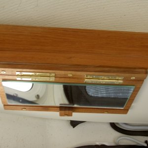 Media 'Vanity mirror: front close-up in folded mode.' in album 'Valkyrie: Fold-down vanity mirror is glued to teak. Brass hinges and screws are used.  In response to a few PM's: the mirror wasn't centered on the aisle because that space is reserved for future projects.  The mirror is only sightly above the other seat, but can easily be used when standing in the aisle.'