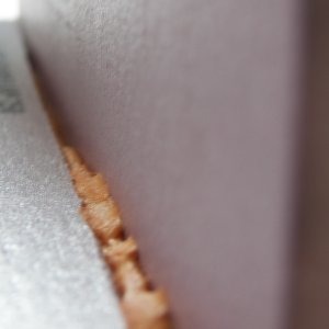The foam cures to a stage that is similar to a roasted marshmallow when cooling.  At a certain point it is still in a plastic state, but not sticky on the exterior.  Any areas that were over filled can be pushed into a fillet using a finger.