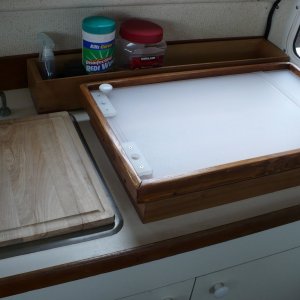 Nice raised work space for us tall folks. Stove feet fit into the holes to keep it from moving. Cutting board is removable. Counter lifts up, storage under.