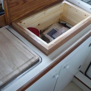 Top lifts up and there is a nice storage area under the cutting board