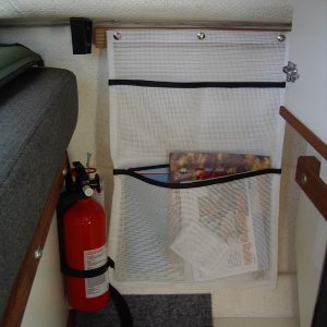 storage pocket on port wall under table.  Snaps attach pocket to oak strip, glued to wall.