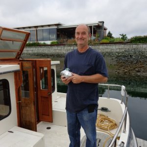 Bill holds a loaf of zucchini bread for him and the crew. Don't need a mutiny on the way home.