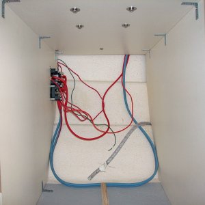(AnchortownJim) Pulled out the useless ice box beneath the helm seat.  The object on the left is a Blue Seas Systems 8080 2 bank battery switch with a DC Breaker.