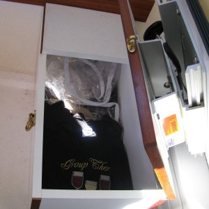 Co-Pilot Seat Storage.  Please notice the high quality brass latch and the sliding, swivel seat.  We can access this space even when in the full sleeping configuration.