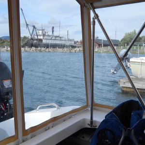 Canvasback Cockpit Enclosure is approximately 89" wide by 74" long by 75" high.  It affords such a wonderful view, that we decided to keep it clear, and order three screen windows for summer use (back-middle, port and starboard front)