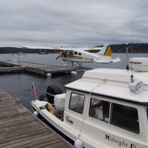 Midnight Flyer tied up near a float plane.