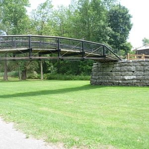 "Low bridge, everybody down" is the song we've all learned in grammer school.  This is one of the early bridges sold to a farmer when the barge canal was built. A flood damaged it and it was then salvaged by volunteers.  It was rebuilt to display the first iron bridge in the world.  Note the rocks on the abutment.  It was built by heavy equipment by the volunteers.  It does not have near the workmanship quality of the old hand done stone work.