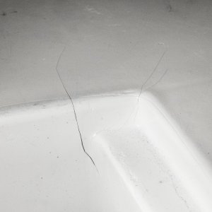 Crack in gelcoat at forward port side of portable toilet storage area.
