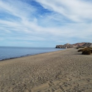 The beach at San Luis Gonzaga, Papa Fernandez's beach camp, typically flat calm, lake like, Sea of Cortez unless of one of the occasional northers is blowing. January weather today mid 70s.