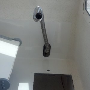 Cut opening to route exhaust pipe.