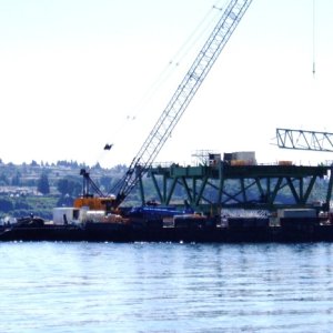 This deck section is 116 feet long, and weighs over 450 tons. The mast on the front of the barge is the GPS antenna.