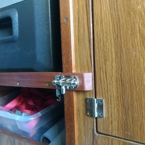 While I doubt the fridge shelf would slide out on it's own I added this spiffy little slide bolt latch to secure it while underway, "just in case".