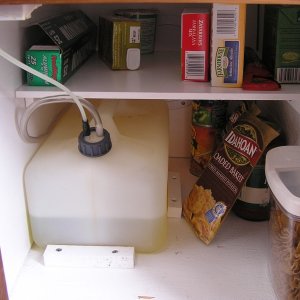 Storage under stove-on floor: moved stove tank then added shelf