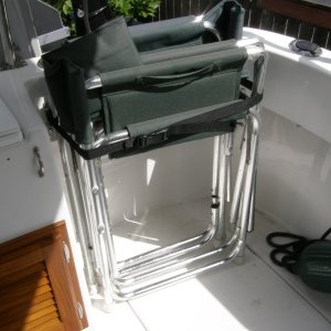 Two folding chairs with added rubber feet, strapped into cockpit
