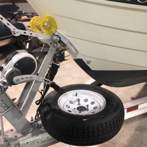 Spare tire used as stand for winching in boat.