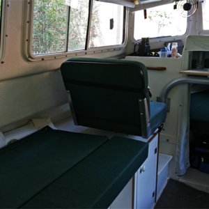 Port Bed and Seat shown with cushion to extend width. With extender cushion and support removed, port side is a bench seat as in the original commuter configuration, Copilot seat modified to slide and rotates.