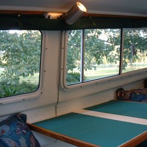 Curtains held up by nylon straps and snaps.