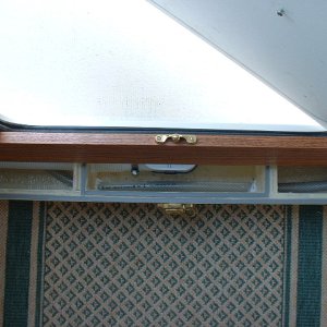 Center compartment is glassed to be watertight. The water supply line for the sink runs through and is siliconed to prevent leakage into the smaller storage compartments.