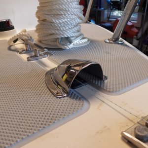 The through-deck block gets a clam shell vent cover to keep rain out.  In the background is the anchor rode that I was going to use, ready to be sent through the blocks using the string.  I changed to using sinking "crab pot" line.  That wasn't as heavy as I wanted, so I'm now using the sinking lead line that is used on the bottom of a gill net.